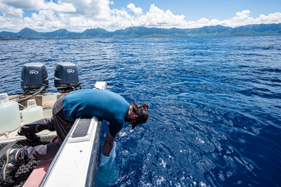 photo of man in boat in the ocean