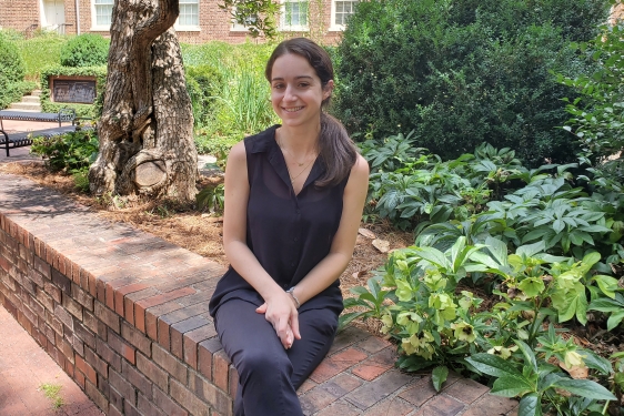 photo of woman posed on low wall, day
